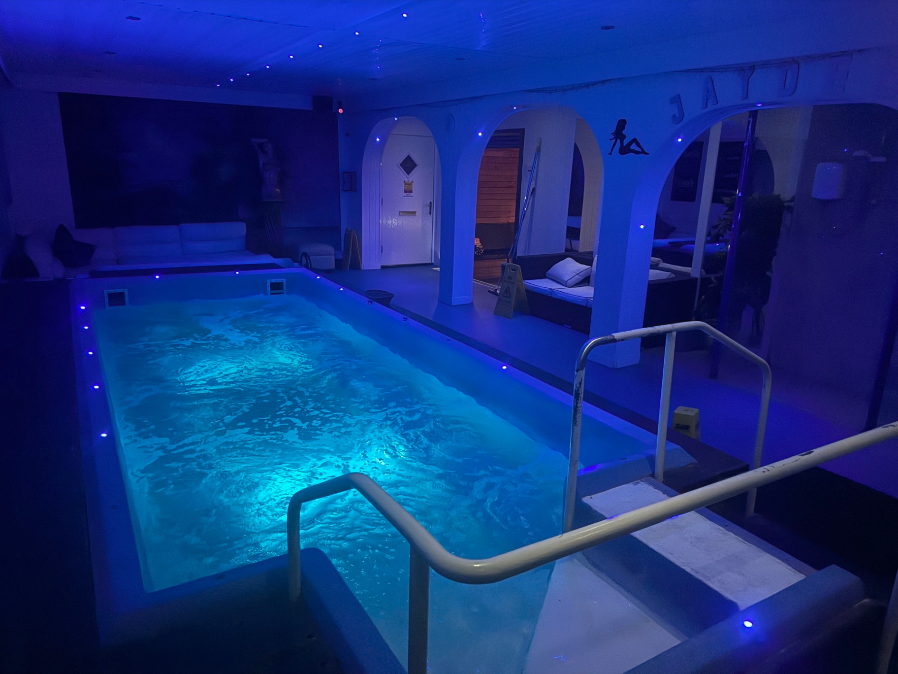 The 30-seater hot tub at Jaydees, softly lit in blue