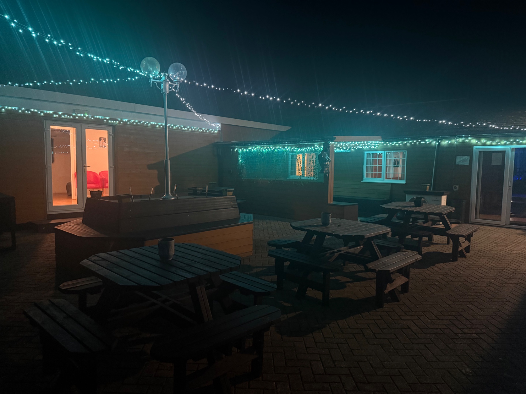 Courtyard at night lit by fairy lights